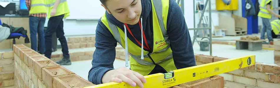 student with a spirit level